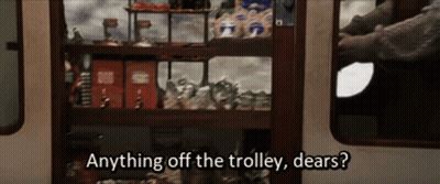 A Person Is Standing In Front Of A Shelf That Says Anything Off The Trolley Dears ? GIF