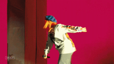 A Person Is Standing In Front Of A Sign That Says Gazella GIF