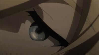 A Person Is Standing In Front Of A Statue With A Light Coming Out Of It In A Dark Room . GIF