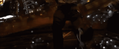 A Person Is Standing In Front Of A Window In A Dark Room With A Candle . GIF
