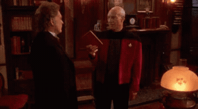 A Person Is Standing In Front Of A Window With A Bullet Hole In It . GIF