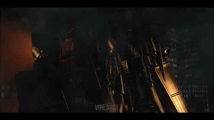 A Person Is Standing In Front Of A Yellow Light . GIF