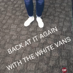 A Person Is Standing On A Brick Sidewalk With The Words " Back At It Again With The White Vans " Written On The Ground GIF