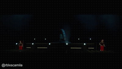 A Person Is Standing On A Stage With A Globe In The Background GIF