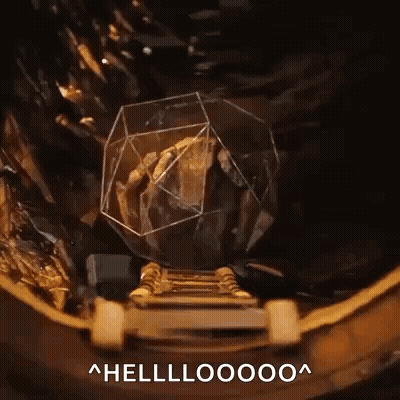 A Person Is Standing On A Staircase Next To A Rock In A Glass Cube With The Words Hellooooo Written Below It . GIF