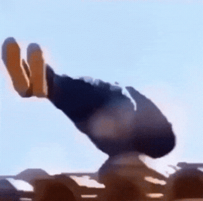 A Person Is Standing On Top Of A Sand Dune In The Desert With A Blue Sky In The Background . GIF