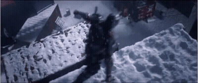 A Person Is Standing On Top Of A Snow Covered Concrete Block . GIF