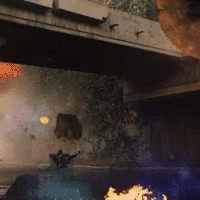 A Person Is Standing Under A Bridge With A Fire Coming Out Of It GIF