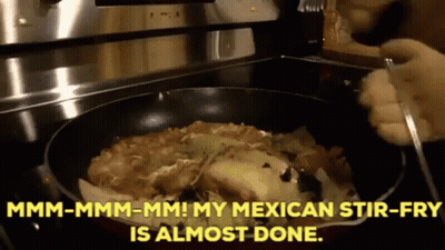 A Person Is Stirring A Mexican Stir Fry In A Frying Pan On A Stove GIF