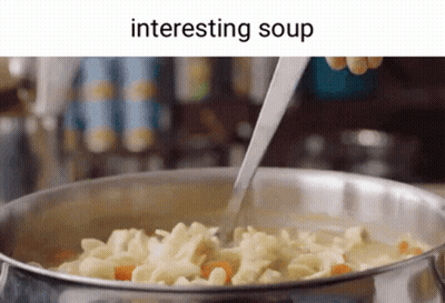 A Person Is Stirring A Pot Of Soup With A Spoon GIF