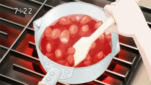 A Person Is Stirring Strawberries In A Pot On A Stove With A Spatula . GIF