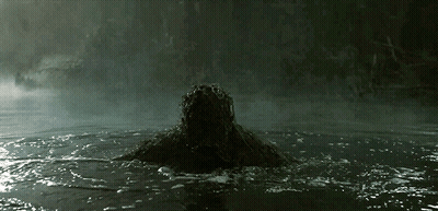 A Person Is Swimming In A Dark Pool With A Dark Background GIF