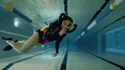A Person Is Swimming In A Pool And The Word Scuba Is On Their Swimsuit GIF