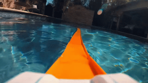 A Person Is Swimming In A Swimming Pool With A Yellow Item In The Water GIF
