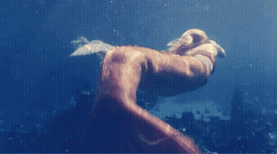 A Person Is Swimming In The Ocean And Their Feet Are Visible GIF