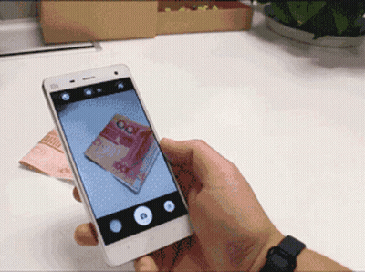 A Person Is Taking A Picture Of A 100 Yuan Bill On Their Phone GIF