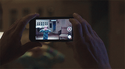 A Person Is Taking A Picture Of A Child On A Cellphone GIF