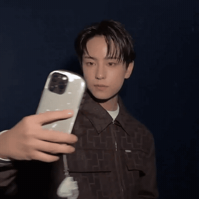 A Person Is Taking A Picture Of A Man With A Phone GIF