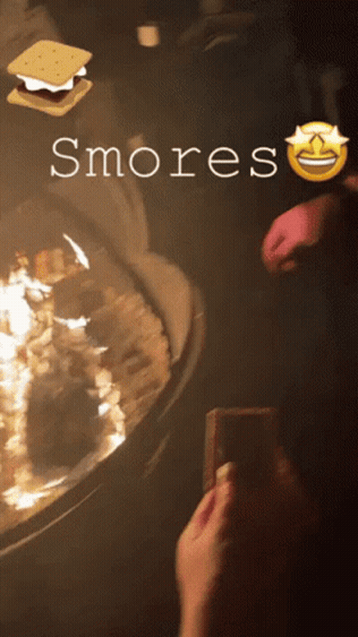 A Person Is Taking A Picture Of Smores With A Smiley Face GIF