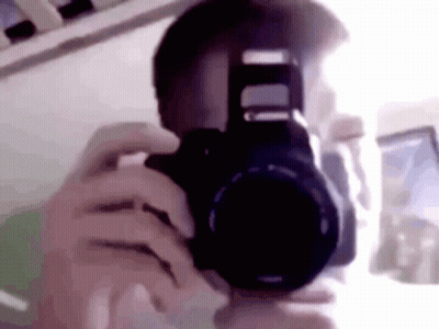 A Person Is Taking A Picture Of Their Face With A Camera . GIF