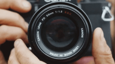 A Person Is Taking A Picture With A Canon Lens Made In Japan GIF