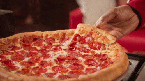 A Person Is Taking A Piece Of Pepperoni Pizza GIF
