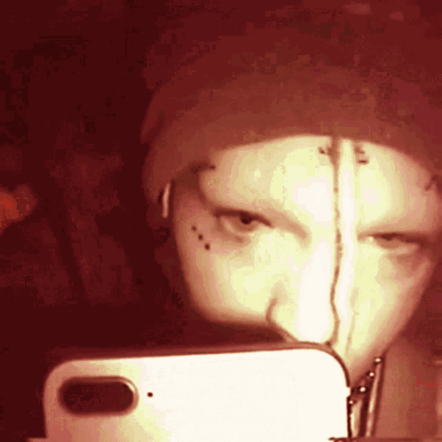 A Person Is Taking A Selfie With A Cell Phone GIF