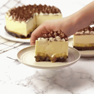 A Person Is Taking A Slice Of Cake From A Plate GIF