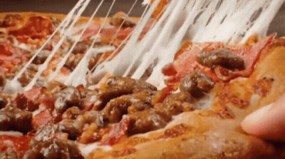 A Person Is Taking A Slice Of Pizza With Meat And Cheese . GIF
