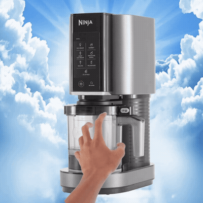 A Person Is Touching A Ninja Coffee Maker With A Blue Sky In The Background GIF