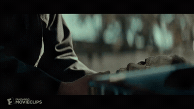 A Person Is Touching A Skeleton 'S Face In A Movie Scene . GIF