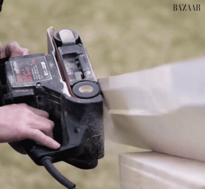 A Person Is Using A Belt Sander Which Says Craftsman On It GIF