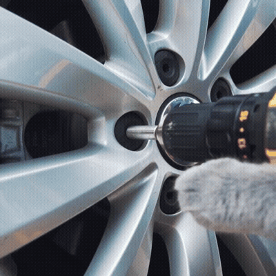 A Person Is Using A Drill To Remove A Screw From A Wheel GIF