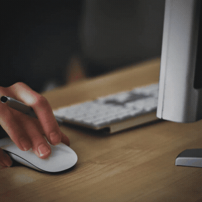 A Person Is Using A Mouse And A Pen GIF