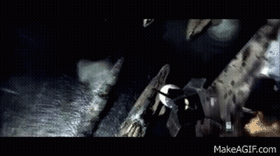 A Person Is Walking Down A Hallway With Pipes Hanging From The Ceiling GIF