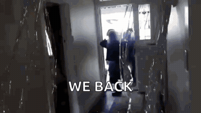 A Person Is Walking Down A Hallway With The Words We Back Written On The Bottom GIF