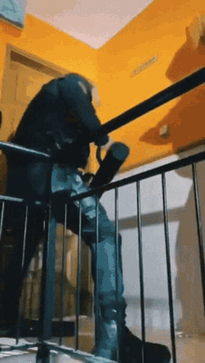 A Person Is Walking Down A Set Of Stairs With A Umbrella . GIF