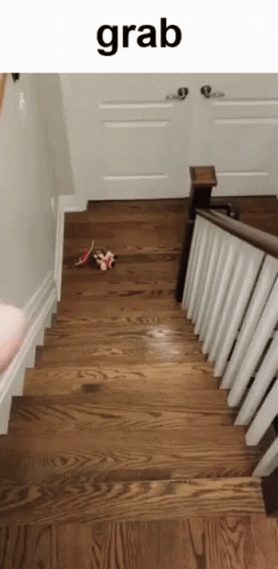 A Person Is Walking Down A Set Of Wooden Stairs With The Word Grab Written Above Them GIF