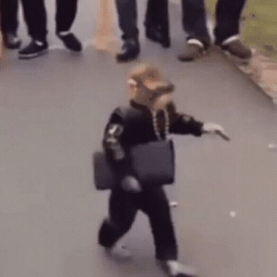A Person Is Walking Down The Street With A Bag On Their Shoulder . GIF