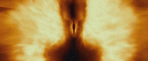 A Person Is Walking Through A Tunnel Of Fire And Smoke GIF