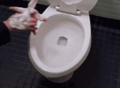 A Person Is Washing Their Hands On A Toilet GIF