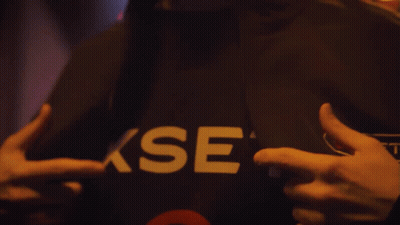 A Person Is Wearing A Black Shirt With The Word Xset On It GIF