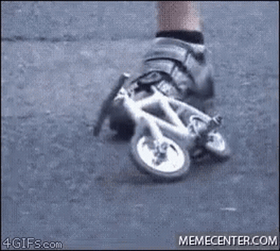 A Person Is Wearing A Pair Of Shoes That Look Like A Small Bicycle . GIF