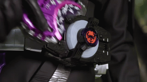 A Person Is Wearing A Purple And Black Belt With A Purple And Orange Item On It GIF