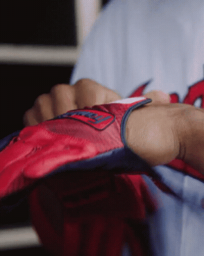 A Person Is Wearing A Red And Blue Glove With The Word Washington On It GIF