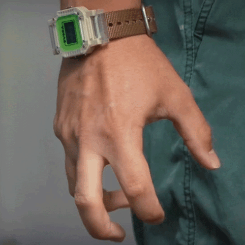A Person Is Wearing A Watch With A Green Face And A Brown Band GIF