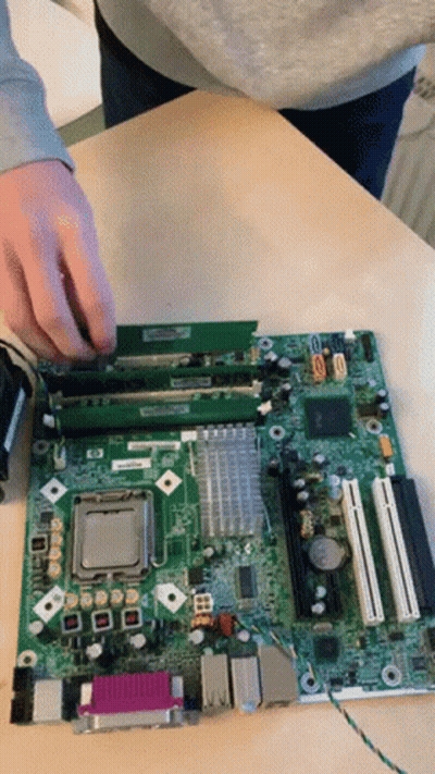 A Person Is Working On A Motherboard That Says Hp GIF