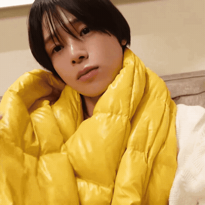 A Person Is Wrapped In A Yellow Scarf GIF