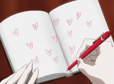 A Person Is Writing In A Notebook With Red Hearts Drawn On It GIF