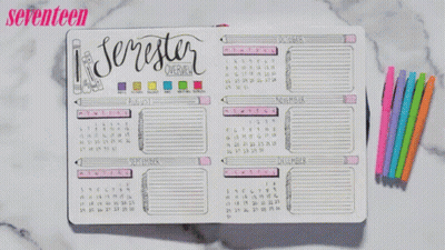 A Person Is Writing In A Notebook With Seventeen Written On The Top GIF
